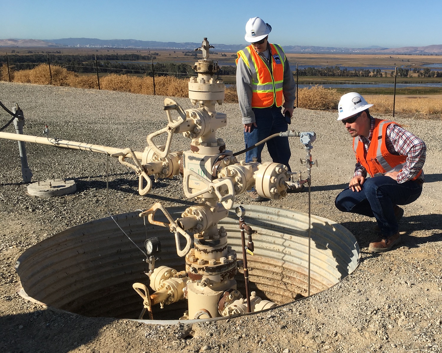 CalGEM engineers inspecting wellhead in a natural gas storage field