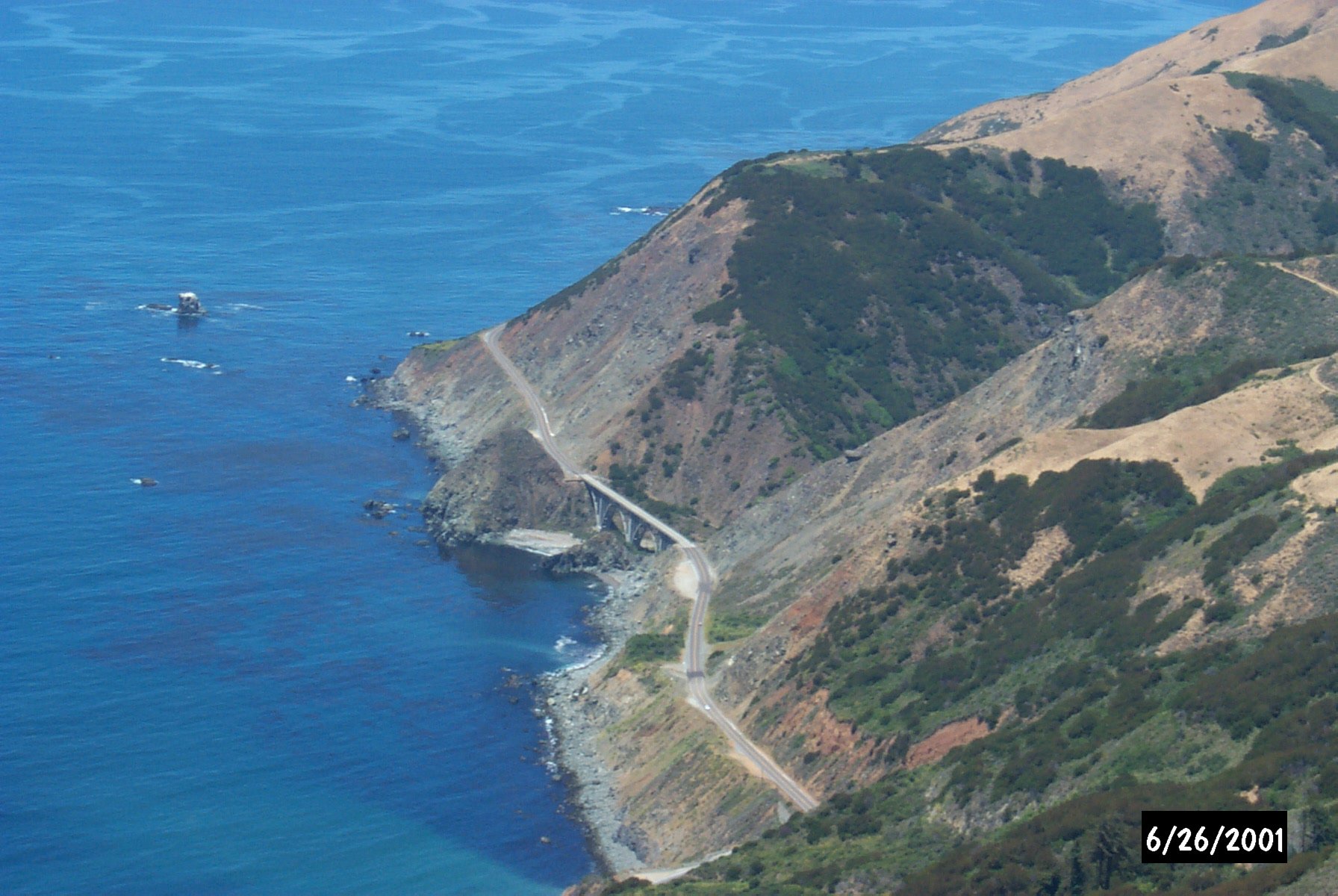 Highway 1 traverses steep hillsides along the Big Sur coast.