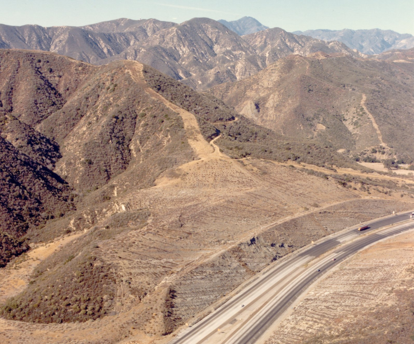 Interstate 5 traverses ruggen barren terrain in northern Los Angeles county.