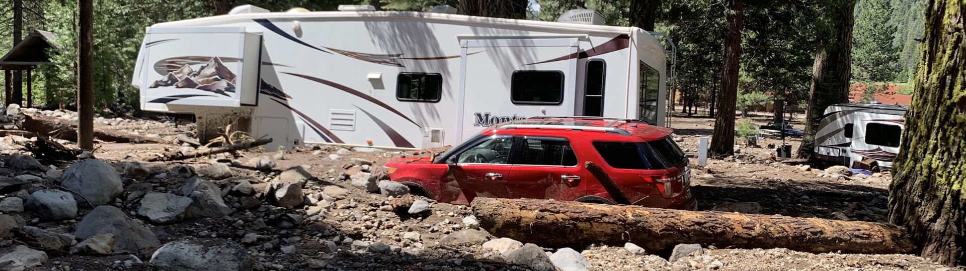 Vehicles trapped in debris. The figure caption provides more information.