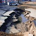 Parking lot severely damaged by liquefaction.