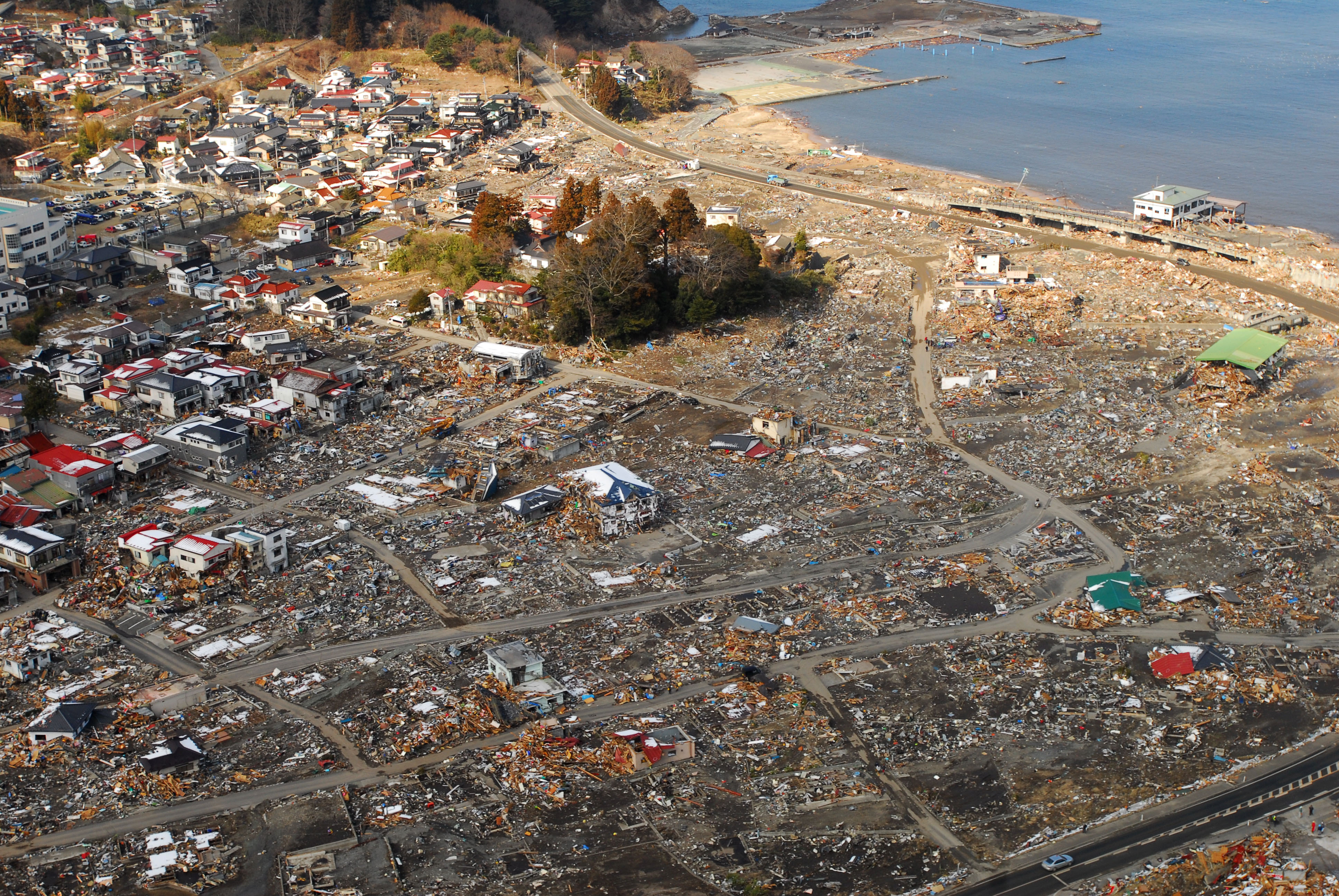Aerial view overlooking a city in Japan after the Tōhoku tsunami flooded the land and destroyed many of the buildings.