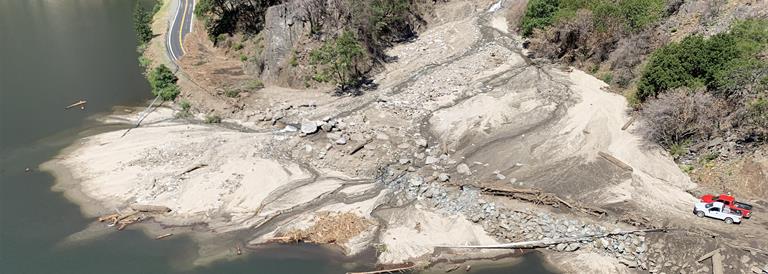 Debris fan projecting into water. The figure caption provides more information.