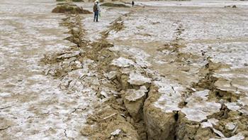 Earthquake fault on desert surface.