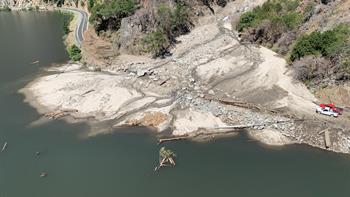 Large-scale debris flow covering a road.